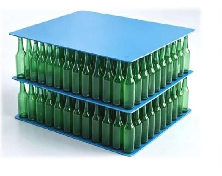 PP bottle tray pads separating stacked green glass bottles