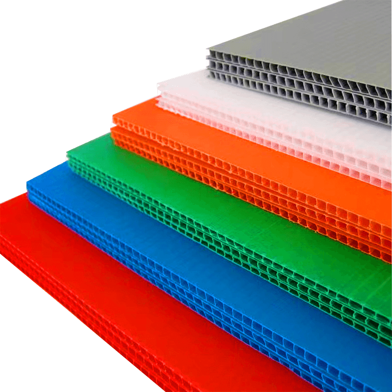 Stack of colorful PP corrugated plastic sheets showing the hollow flute edges