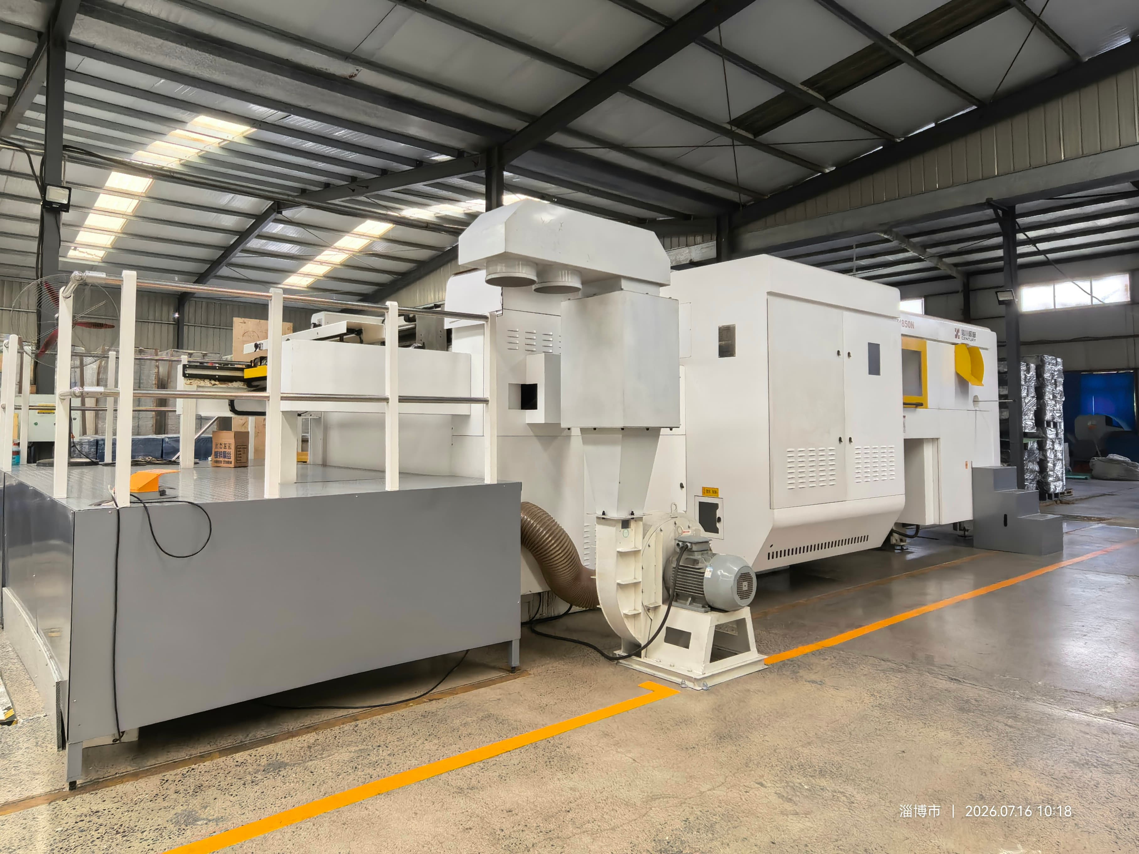 1850 flatbed die-cutting and waste-removal equipment inside the Zibo workshop